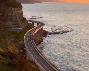 Preview wallpaper road, cars, bends, sea, aerial view
