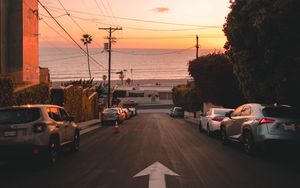 Preview wallpaper road, cars, coast, pointer
