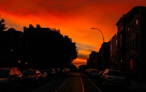 Preview wallpaper road, cars, street, sunset, distance