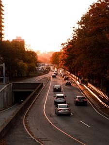 Preview wallpaper road, cars, traffic, sunset