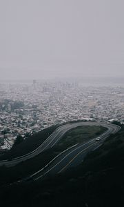 Preview wallpaper road, city, aerial view, fog, buildings, car