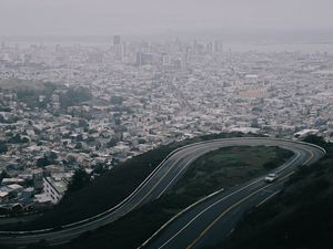 Preview wallpaper road, city, aerial view, fog, buildings, car
