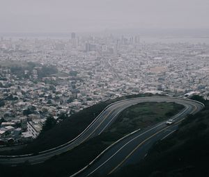 Preview wallpaper road, city, aerial view, fog, buildings, car