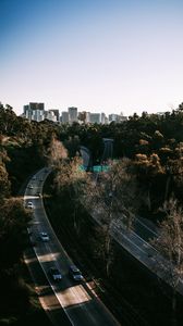Preview wallpaper road, city, aerial view, buildings, trees