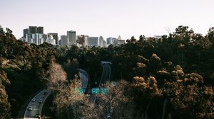 Preview wallpaper road, city, aerial view, buildings, trees