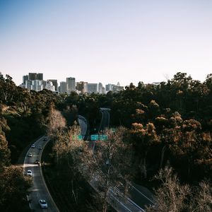 Preview wallpaper road, city, aerial view, buildings, trees