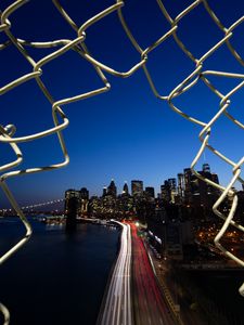 Preview wallpaper road, city, buildings, night, lights, coast, grid