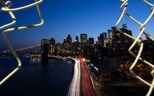 Preview wallpaper road, city, buildings, night, lights, coast, grid