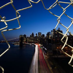 Preview wallpaper road, city, buildings, night, lights, coast, grid