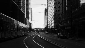 Preview wallpaper road, city, bw, buildings, cars