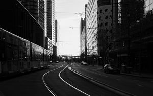 Preview wallpaper road, city, bw, buildings, cars