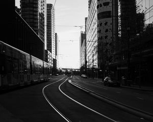 Preview wallpaper road, city, bw, buildings, cars