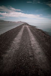 Preview wallpaper road, coast, stones, water, hills, clouds