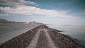 Preview wallpaper road, coast, stones, water, hills, clouds