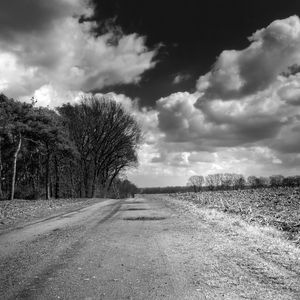 Preview wallpaper road, country, black-and-white, trees, clouds, volume