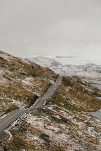 Preview wallpaper road, distance, rocks, snow, snowy