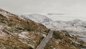 Preview wallpaper road, distance, rocks, snow, snowy