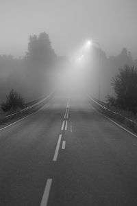 Preview wallpaper road, fog, bridge, streetlights, asphalt, forest, bw