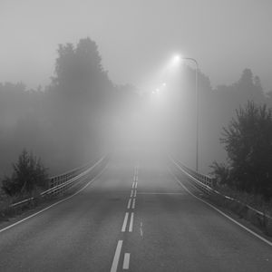 Preview wallpaper road, fog, bridge, streetlights, asphalt, forest, bw