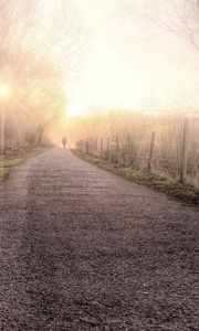 Preview wallpaper road, fog, light, person, silhouette