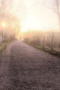 Preview wallpaper road, fog, light, person, silhouette