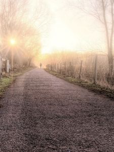 Preview wallpaper road, fog, light, person, silhouette