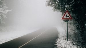 Preview wallpaper road, fog, sign, asphalt, branches