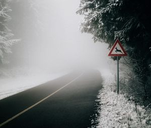 Preview wallpaper road, fog, sign, asphalt, branches