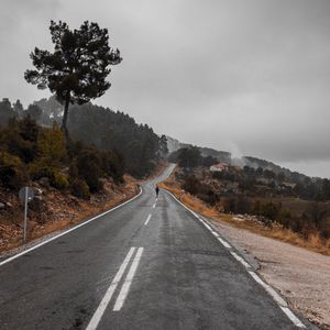 Preview wallpaper road, fog, silhouette, loneliness, tree