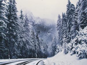 Preview wallpaper road, forest, turn, mountains, snowy, winter, trees