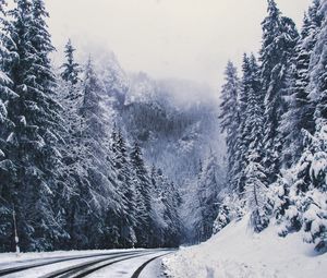 Preview wallpaper road, forest, turn, mountains, snowy, winter, trees