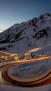 Preview wallpaper road, freezelight, mountains, houses, snow, night