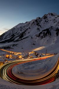 Preview wallpaper road, freezelight, mountains, houses, snow, night