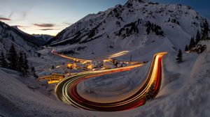 Preview wallpaper road, freezelight, mountains, houses, snow, night