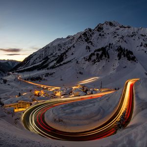 Preview wallpaper road, freezelight, mountains, houses, snow, night
