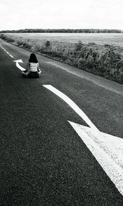 Preview wallpaper road, girl, pose, asphalt, field, bw