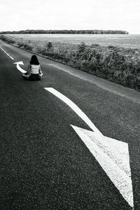 Preview wallpaper road, girl, pose, asphalt, field, bw