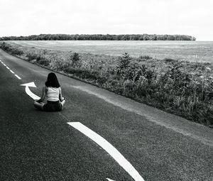 Preview wallpaper road, girl, pose, asphalt, field, bw