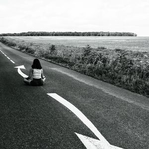 Preview wallpaper road, girl, pose, asphalt, field, bw