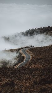 Preview wallpaper road, hill, clouds, aerial view