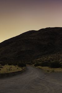 Preview wallpaper road, hill, winding, dusk