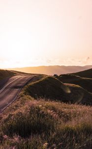 Preview wallpaper road, hilly, relief, landscape, sunrise