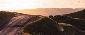 Preview wallpaper road, hilly, relief, landscape, sunrise