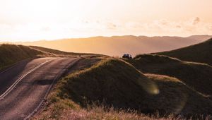 Preview wallpaper road, hilly, relief, landscape, sunrise