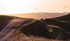 Preview wallpaper road, hilly, relief, landscape, sunrise