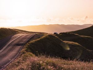 Preview wallpaper road, hilly, relief, landscape, sunrise