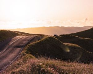 Preview wallpaper road, hilly, relief, landscape, sunrise