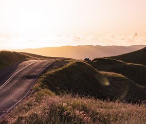 Preview wallpaper road, hilly, relief, landscape, sunrise