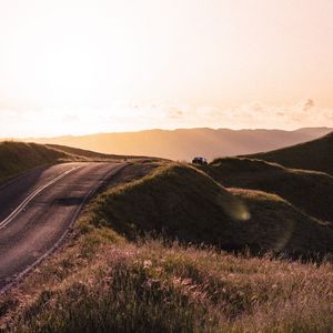 Preview wallpaper road, hilly, relief, landscape, sunrise