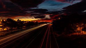 Preview wallpaper road, light, long exposure, trees, sunset, dark